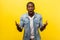 What do you want from me. Portrait of irritated angry man raising hands while disputing. indoor studio shot isolated on yellow