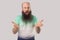 What do you want? Portrait of angry middle aged bald man with long beard in light green t-shirt standing, looking at camera,