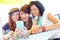 What a great photo. A group of adolescent girls laughing as they look at something on a smartphone screen.