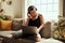 This is what happiness sounds like. a young woman using a laptop and headphones on the sofa at home.