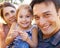 What a happy family. Portrait of a young family enjoying the outdoors.