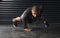 What hurts now will one day be your warm up. Shot of an athletic young man doing pushups in the gym.