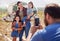 This is what inspires me every day. a man taking a picture of his family on a poultry farm.