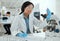 What secrets do you hold. a young scientist reviewing a sample in the lab.