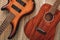 What to choose Top view on two cool musical instruments: acoustic and electric guitars are lying on the wooden floor in