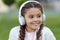 What a wonderful life. Happy girl wear headphones. Little music fan. Little child listen to music outdoor. Happy little