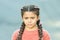 What is wrong. Hairdresser salon. Braided cutie. Little girl with cute braids close up. Kanekalon strand in braids of
