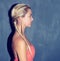 What you see is what you get. Profile shot of a young woman against a blue background.