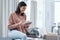 Whatever your work, do it like a boss. a confident young woman using a digital tablet while working from home.