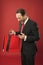 Whats in bags. Happy director look into colorful bags. Mature man hold shopping bags. Sale and discount. Business gifts