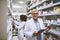 Whats on the menu today. Portrait of a cheerful mature male pharmacist holding a digital tablet and box of meds while