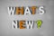 Whats new ? word written with different colored letter blocks on a white background