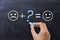 Whatâ€™s missing in life to be happy, with smiley faces on blackboard