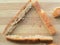 Wheat bread piece triangle on wooden background