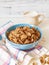 Wheat buckwheat bran breakfast cereal with milk in ceramic bowl