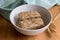 Wheat cereal bars in bowl with wheat spears on wooden table