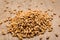 Wheat cereal grain. Pile of grains on the wooden table. Selective focus.