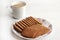 Wheat Coconut biscuits in white plate, Indian biscuits popularly known as Chai-biscuit in India, chai or chaha in india. Tea Time
