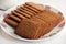 Wheat Coconut biscuits in white plate, Indian biscuits popularly known as Chai-biscuit in India, chai or chaha in india. Tea Time