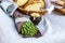 Wheat ear green bouquet kraft paper on gray linen tablecloth background bread basket chopped pot of honey