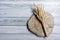 Wheat Ears on Wooden Table. Sheaf of Wheat over Wood Background. Harvest concept.