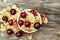 Wheat flakes with cherry pieces in a ceramic pot