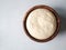 Wheat flour yeast dough in wooden bowl. Top view. Copy space