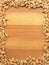 Wheat grain frame on wooden background