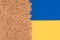 Wheat grain over Ukrainian blue and yellow flag with copy space