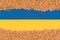 Wheat grain over Ukrainian blue and yellow flag with copy space. Global and European food crisis