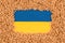 Wheat grain over Ukrainian blue and yellow flag. Global and European food crisis