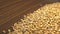 Wheat grains on a brown wooden background. 2 Shots. Slow motion. Vertical pan. Close-up.