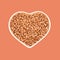 Wheat grains in a plate in the shape of a heart. Favorite food. Agriculture and love. In isolation. Beige and orange background