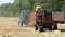 Wheat Harvest. Combine Unloading Wheat into a Tractor Trailer During Harvest.