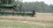 A wheat harvester machine rolling on the field