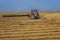 A wheat harvester tractor harvest yellow wheat in the Overberg wheat region of South Africa