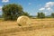 Wheat land with bales of hay