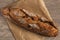 Wheat loaf with dried apricots on a wooden