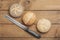 Wheat rolls, poppy seed roll, sesame roll and knife on wood