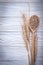 Wheat-rye ears wooden spoon corn on wood board