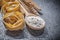 Wheat rye ears wooden spoon flour raw twisted Italian pasta on b