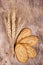 Wheat spikes and cereal biscuits on an old wooden background