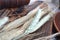 Wheat spikes and grains with rustic ceramic and wooden dish