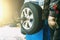 Wheel balancing or repair and change car tire at auto service garage or workshop by mechanic