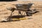 Wheel barrow and other tools used by a builder to make a concrete sidewalk