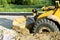 Wheel bulldozer machine for shoveling sand at eathmoving works in construction site