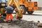 Wheel excavator digging trench on rocky land