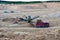 Wheel front-end loader loads sand into a dump truck. Heavy machinery in the mining quarry, excavators and trucks.