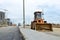 Wheel loader with a bucket on a street in the city during the construction of the road