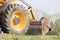 Wheel loader during earth mowing works